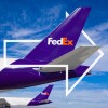 Two FedEx purple-tail aircraft lined up on a clear day with FedEx arrow overlay in white
