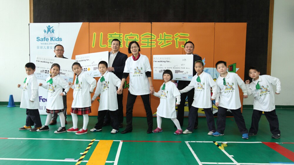 representatives-from-safe-kids-fedex-china-and-pediatrician-take-photo-with-children.jpg