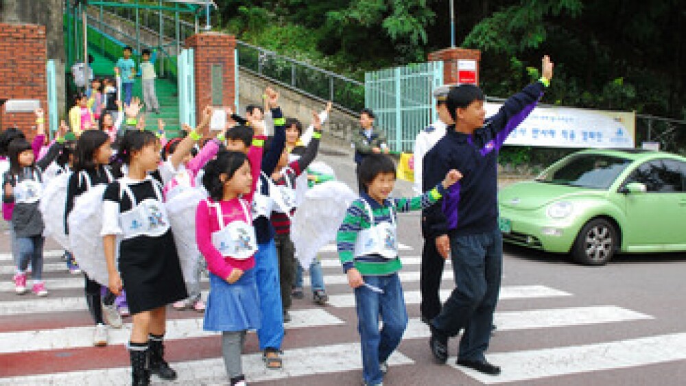 1010-children-are-taking-a-crosswalk-wearing-the-safe-reflective-bracelets.jpg